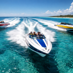 Three speedboats racing on clear blue water near a tropical coastline