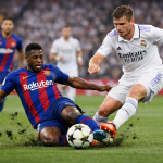 Two soccer players from Barcelona and Real Madrid contest the ball in a sliding tackle