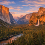 Sunset over Yosemite Valley showing El Capitan on the left and Bridalveil Fall on the right with forest and river below